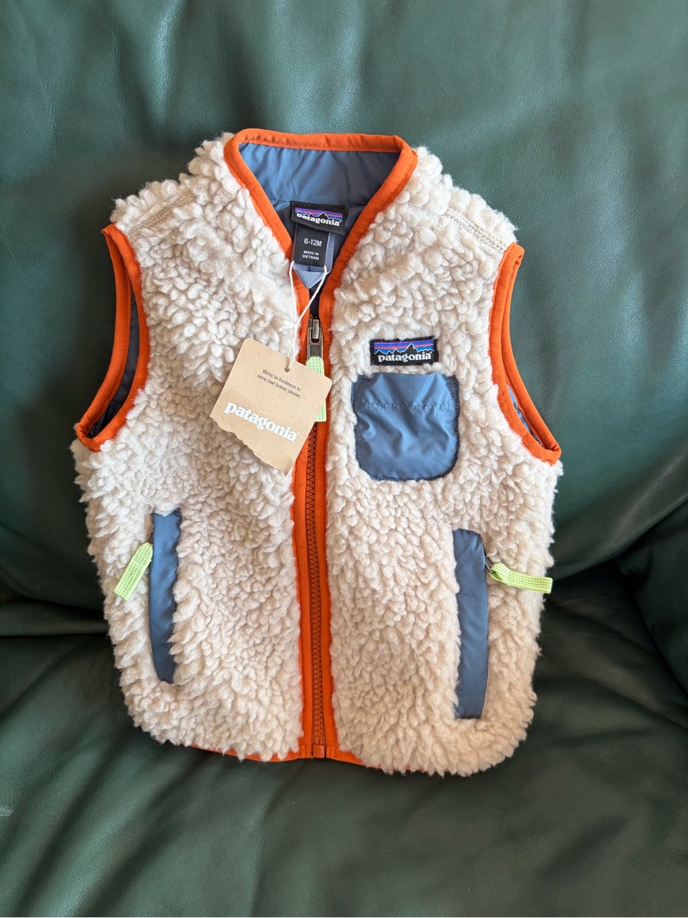 Patagonia Cream Sherpa Vest with Orange Trim and Blue Pockets